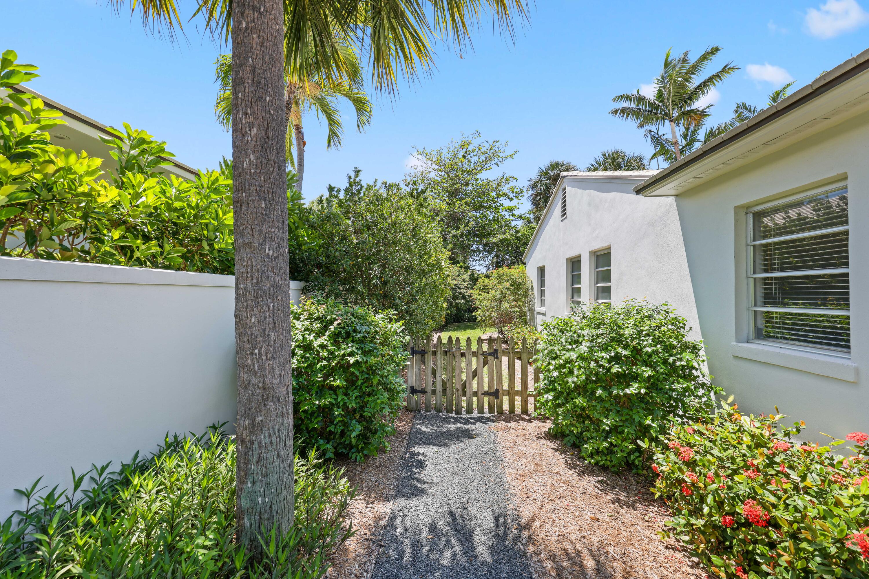 246 Merrain Road Palm Beach, FL 33480 - Photo 24 of 31 a house with a flower garden