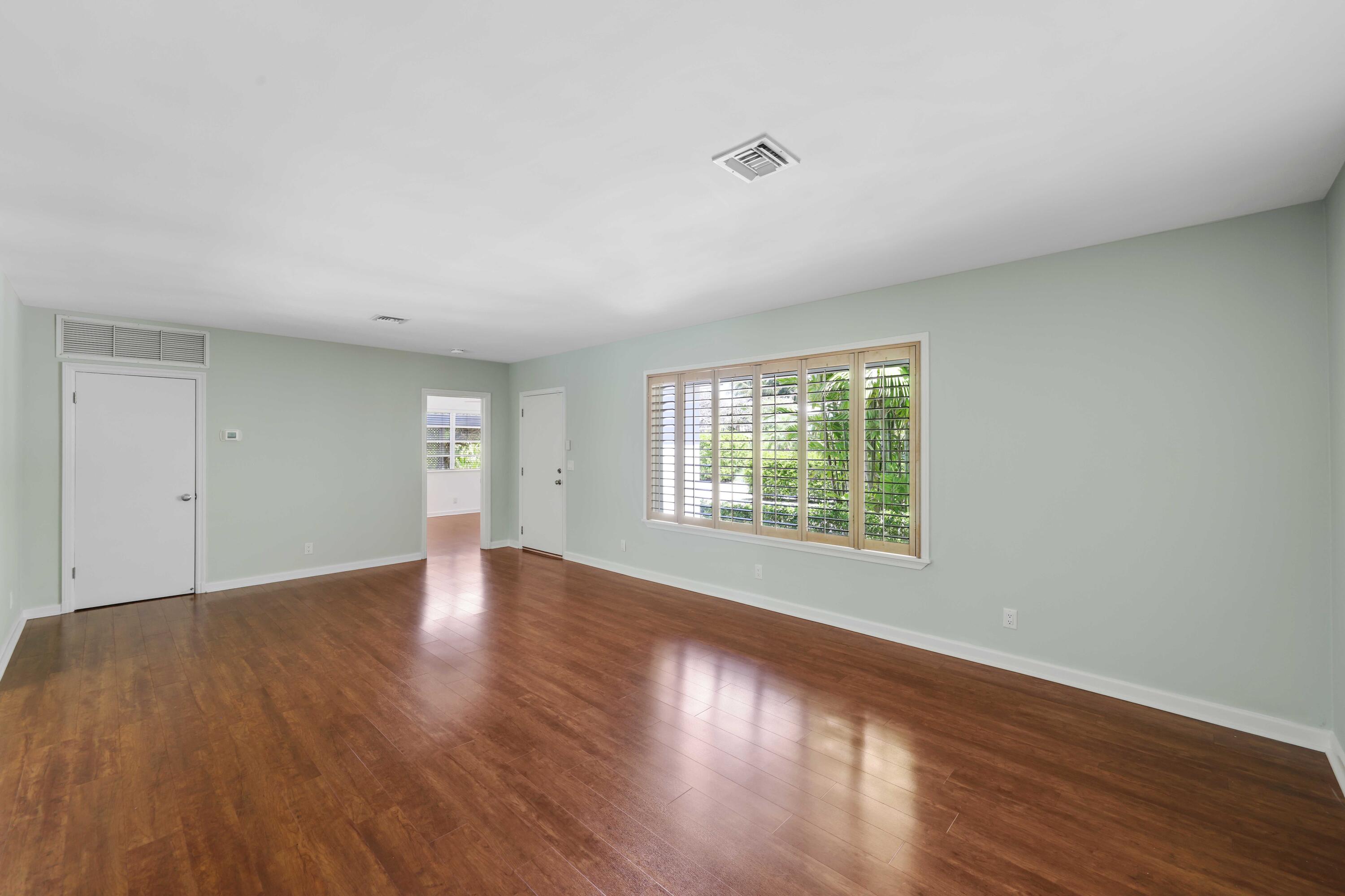 246 Merrain Road Palm Beach, FL 33480 - Photo 4 of 31 an empty room with wooden floor and windows