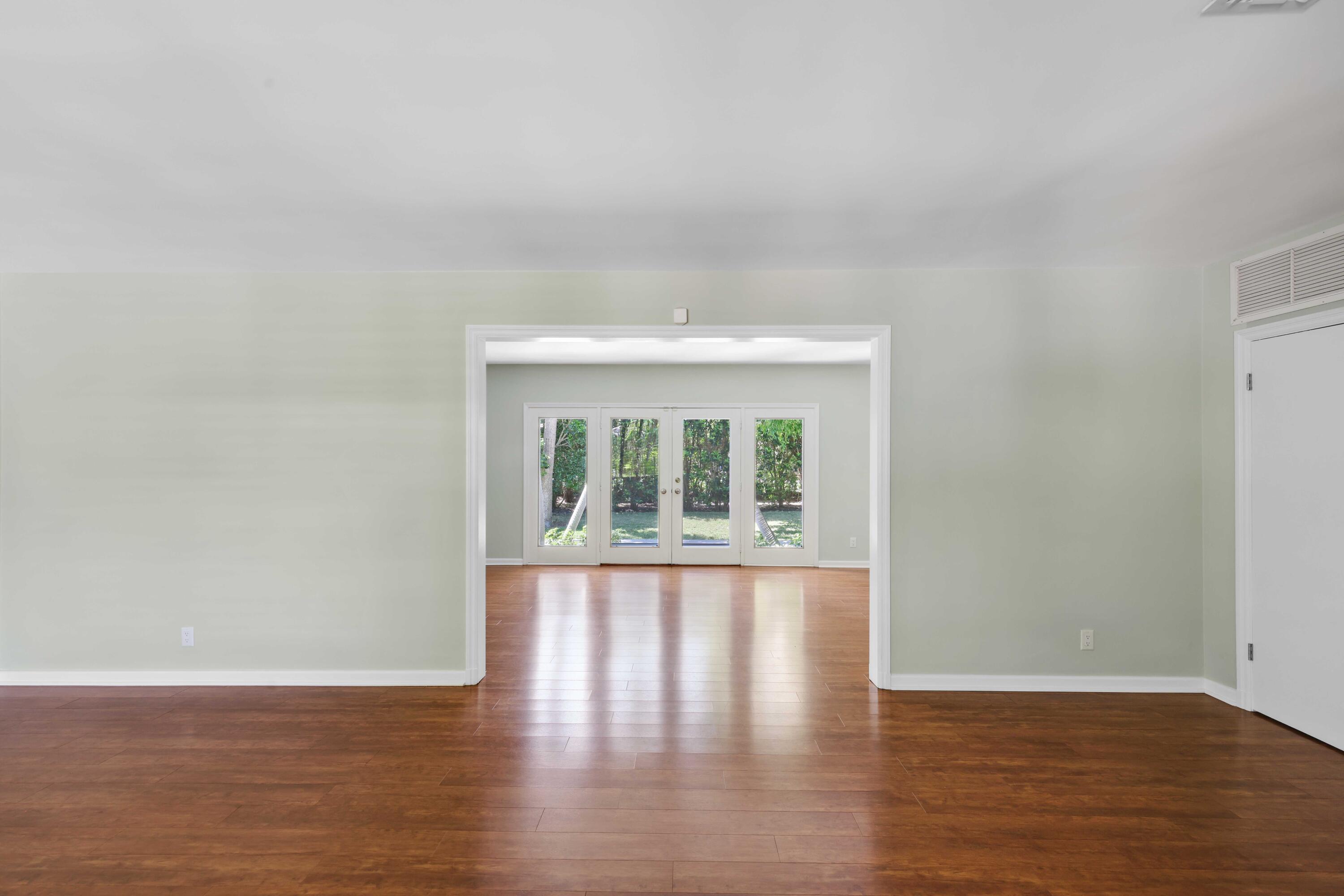 246 Merrain Road Palm Beach, FL 33480 - Photo 5 of 31 a view of an empty room with wooden floor and a window