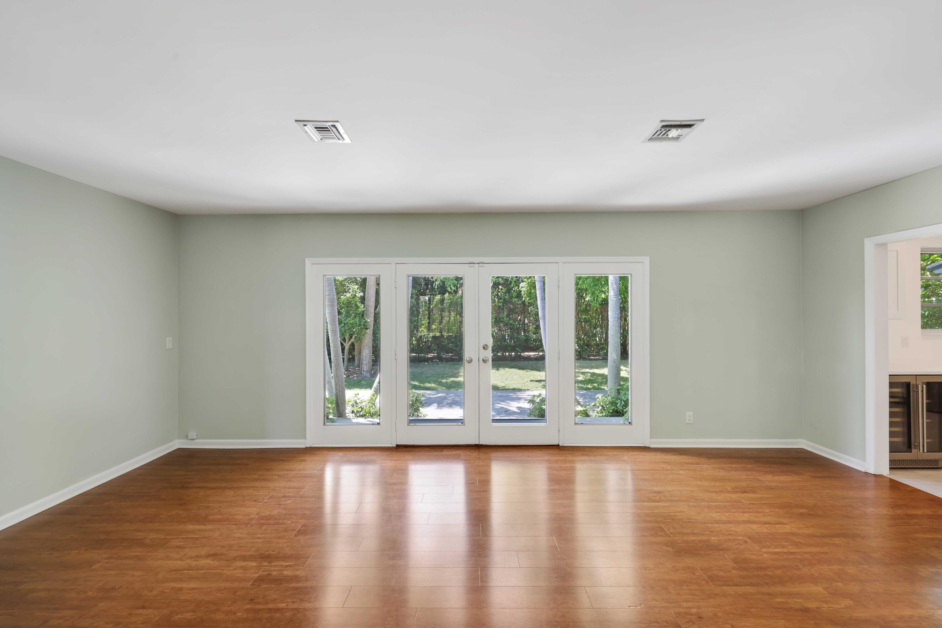 246 Merrain Road Palm Beach, FL 33480 - Photo 6 of 31 a view of an empty room with wooden floor and a window