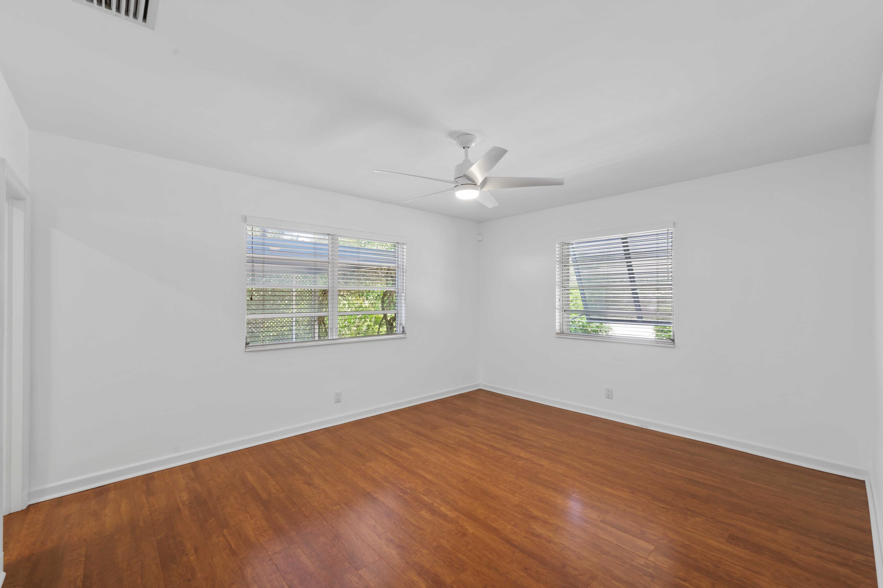 246 Merrain Road Palm Beach, FL 33480 - Photo 7 of 31 wooden floor in an empty room with a window