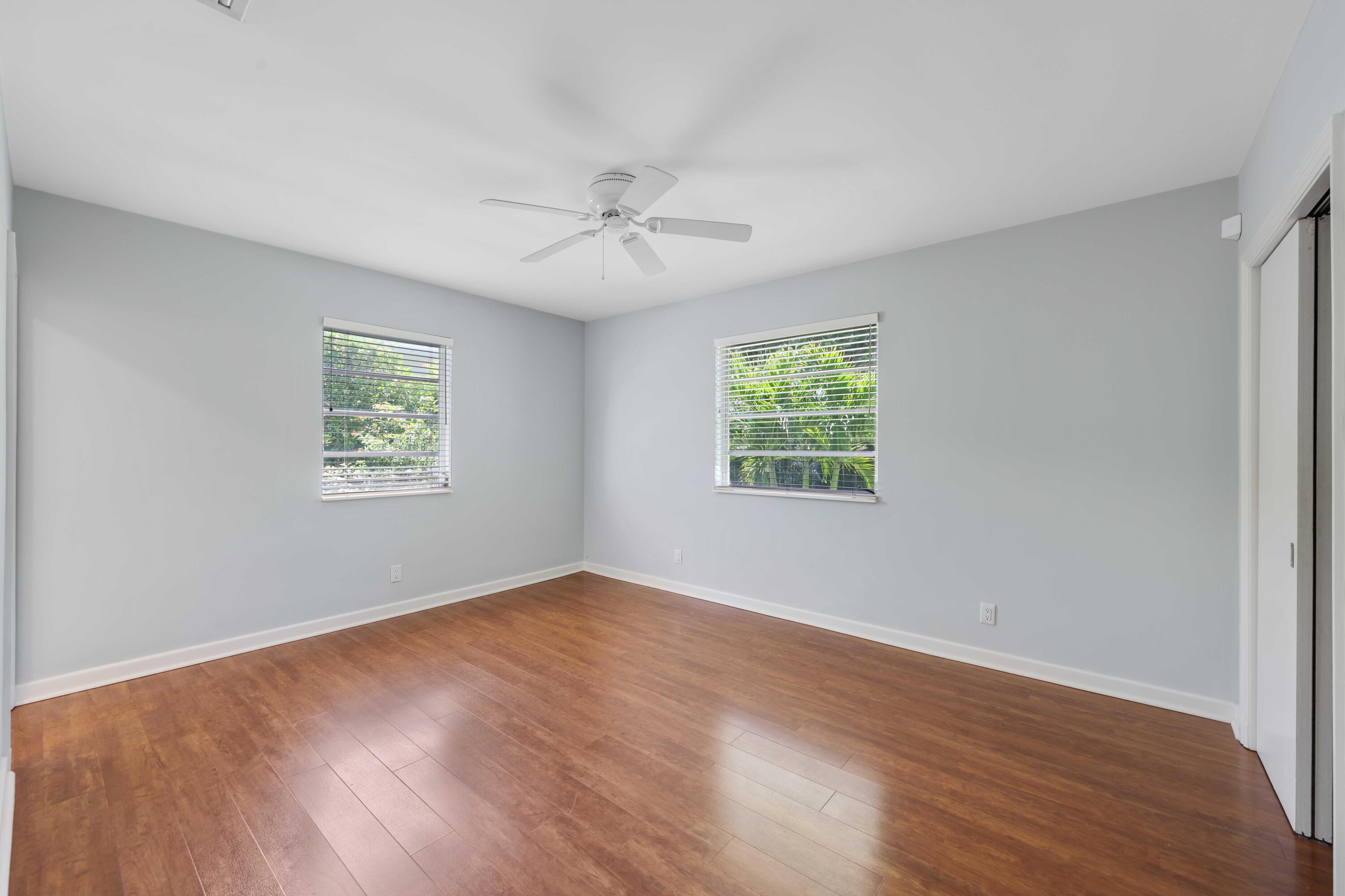 246 Merrain Road Palm Beach, FL 33480 - Photo 9 of 31 a view of an empty room with a window and wooden floor
