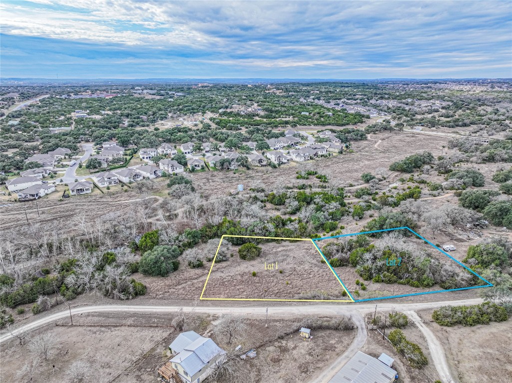 an aerial view of a house with a yard