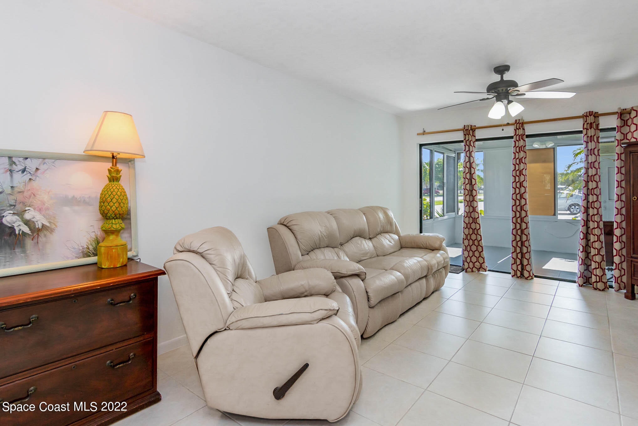 2 Country Club Road, Unit 20 Cocoa Beach, FL 32931 - Photo 11 of 23 a living room with furniture and a chandelier