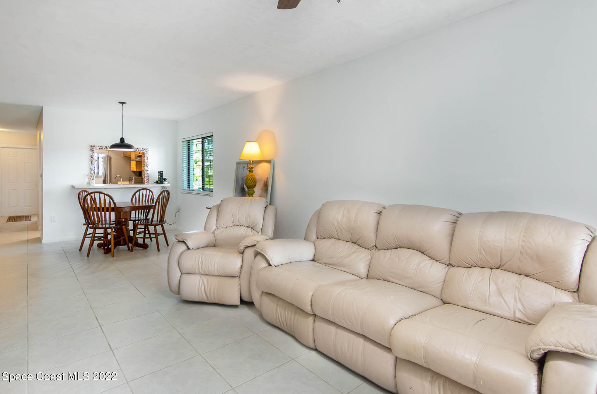 2 Country Club Road, Unit 20 Cocoa Beach, FL 32931 - Photo 12 of 23 a living room with furniture and a wooden floor