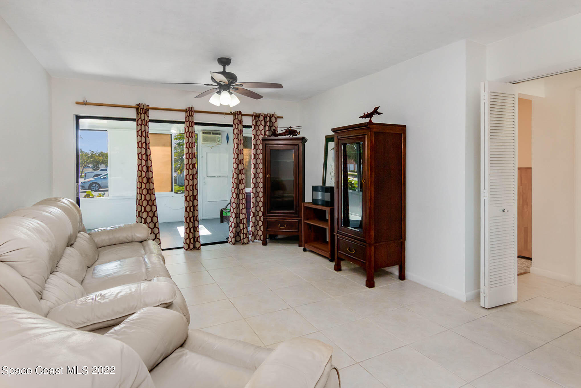 2 Country Club Road, Unit 20 Cocoa Beach, FL 32931 - Photo 13 of 23 a living room with furniture a ceiling fan and a window