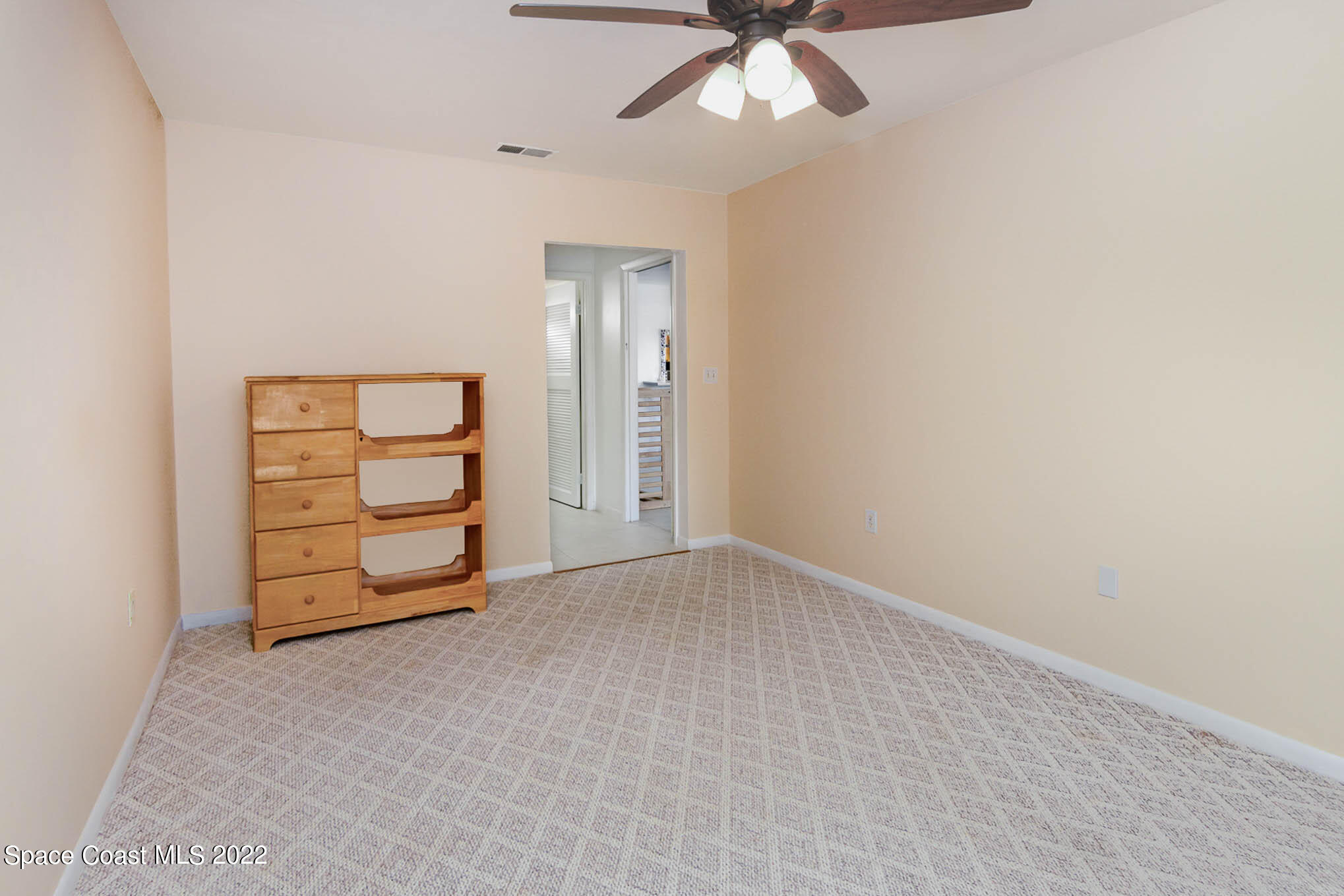 2 Country Club Road, Unit 20 Cocoa Beach, FL 32931 - Photo 17 of 23 an empty room with closet and fan