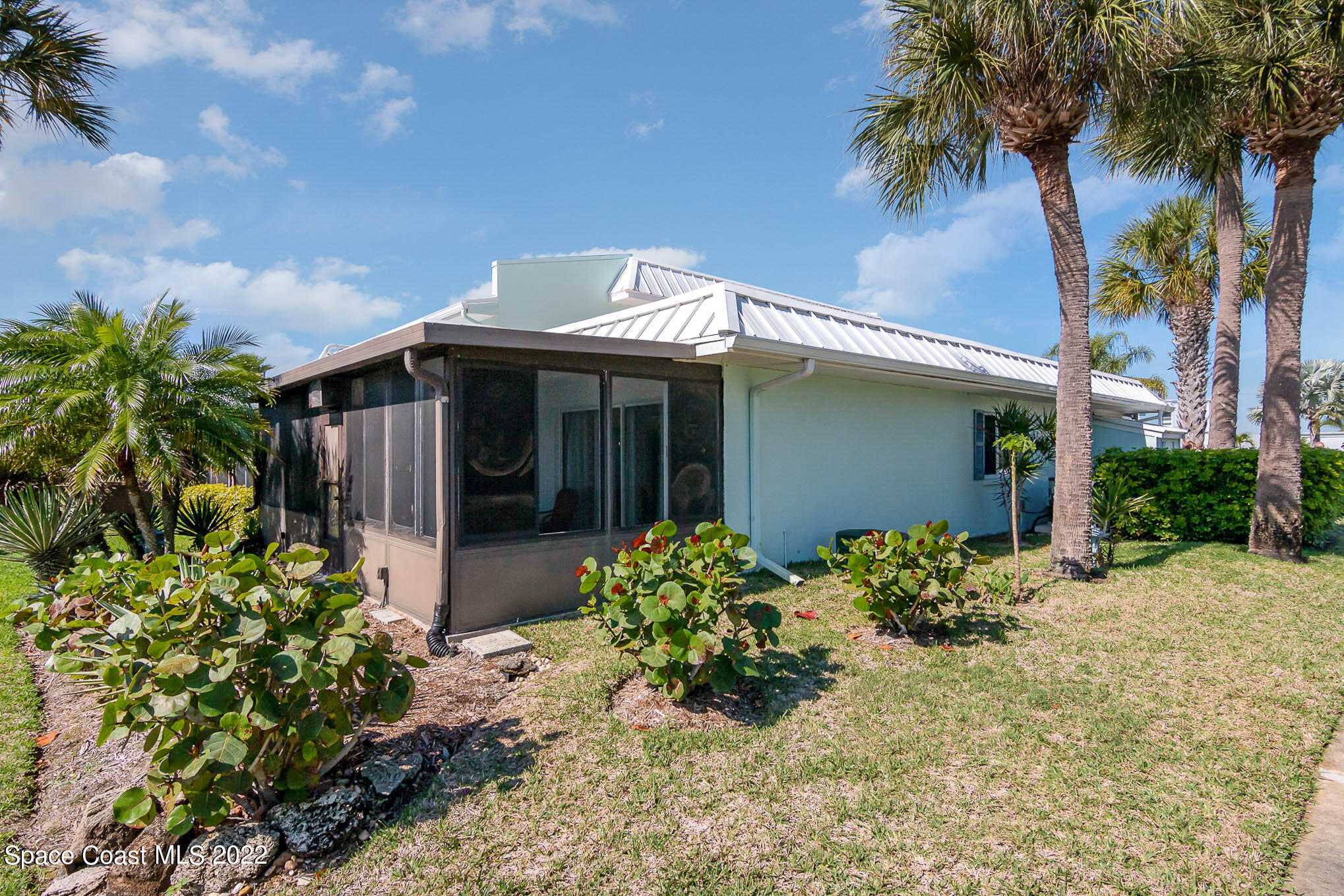 2 Country Club Road, Unit 20 Cocoa Beach, FL 32931 - Photo 20 of 23 a front view of a house with garden