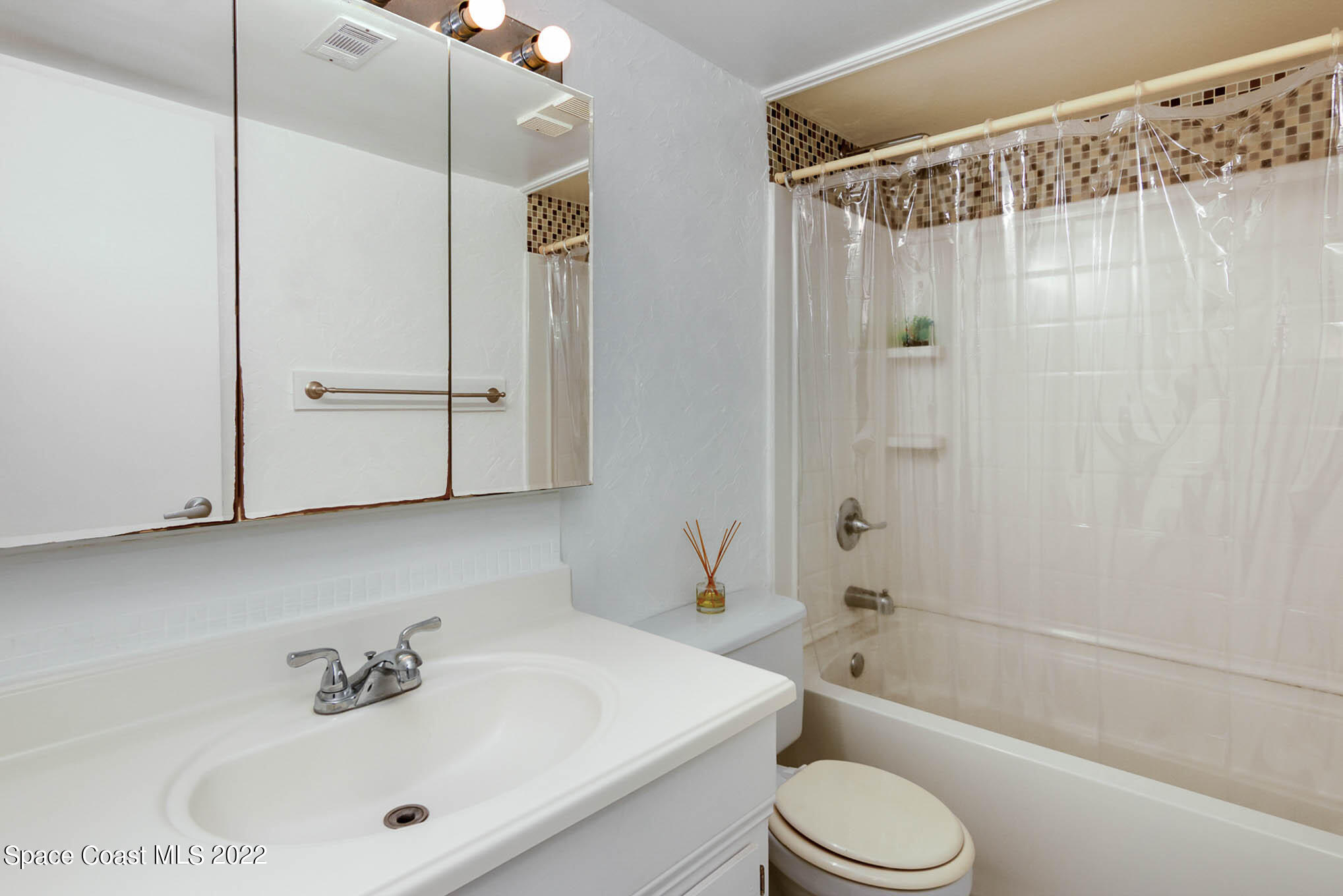 2 Country Club Road, Unit 20 Cocoa Beach, FL 32931 - Photo 5 of 23 a bathroom with a sink a toilet and shower