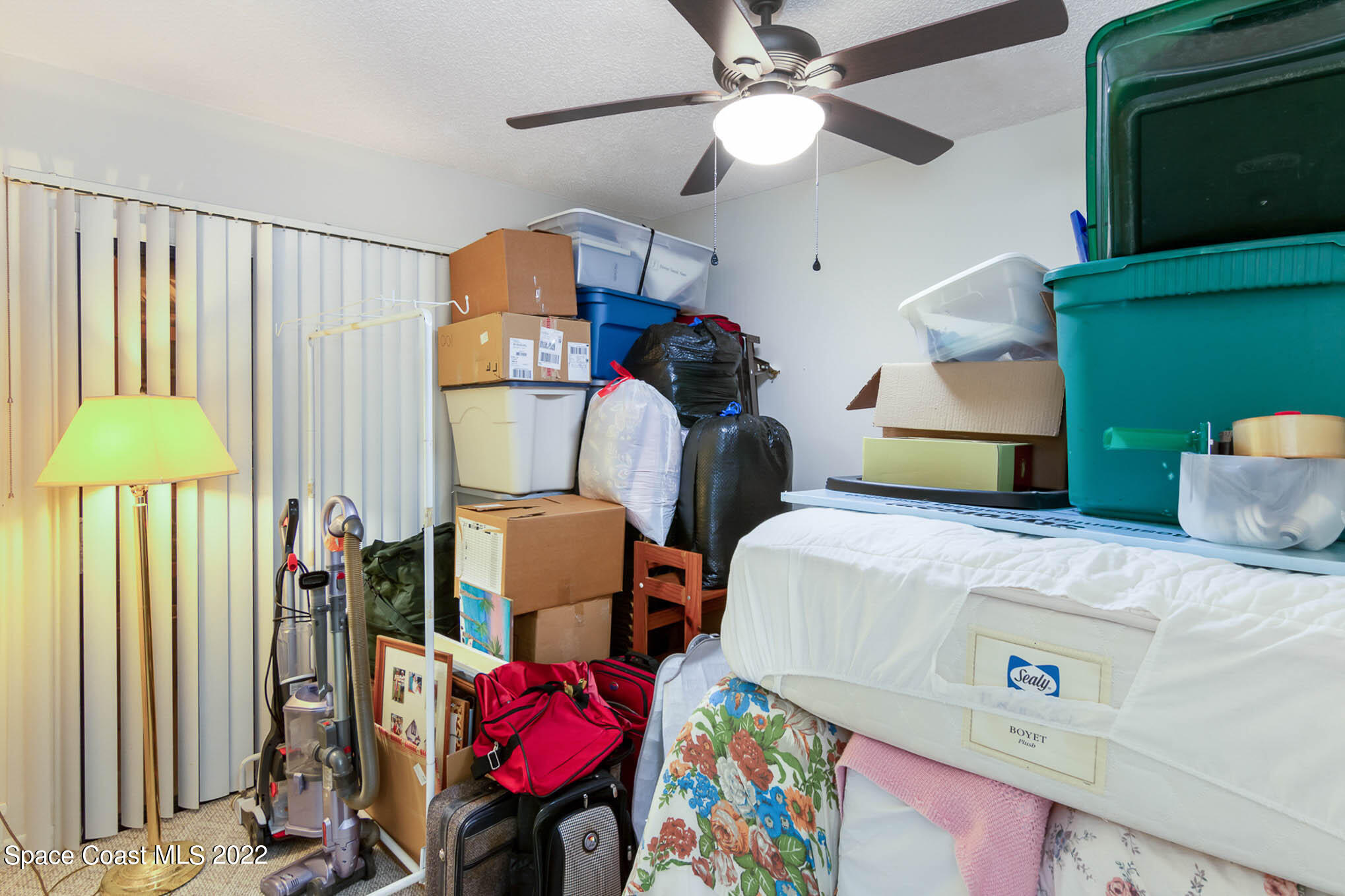 2 Country Club Road, Unit 20 Cocoa Beach, FL 32931 - Photo 6 of 23 a bedroom with bed and a chandelier