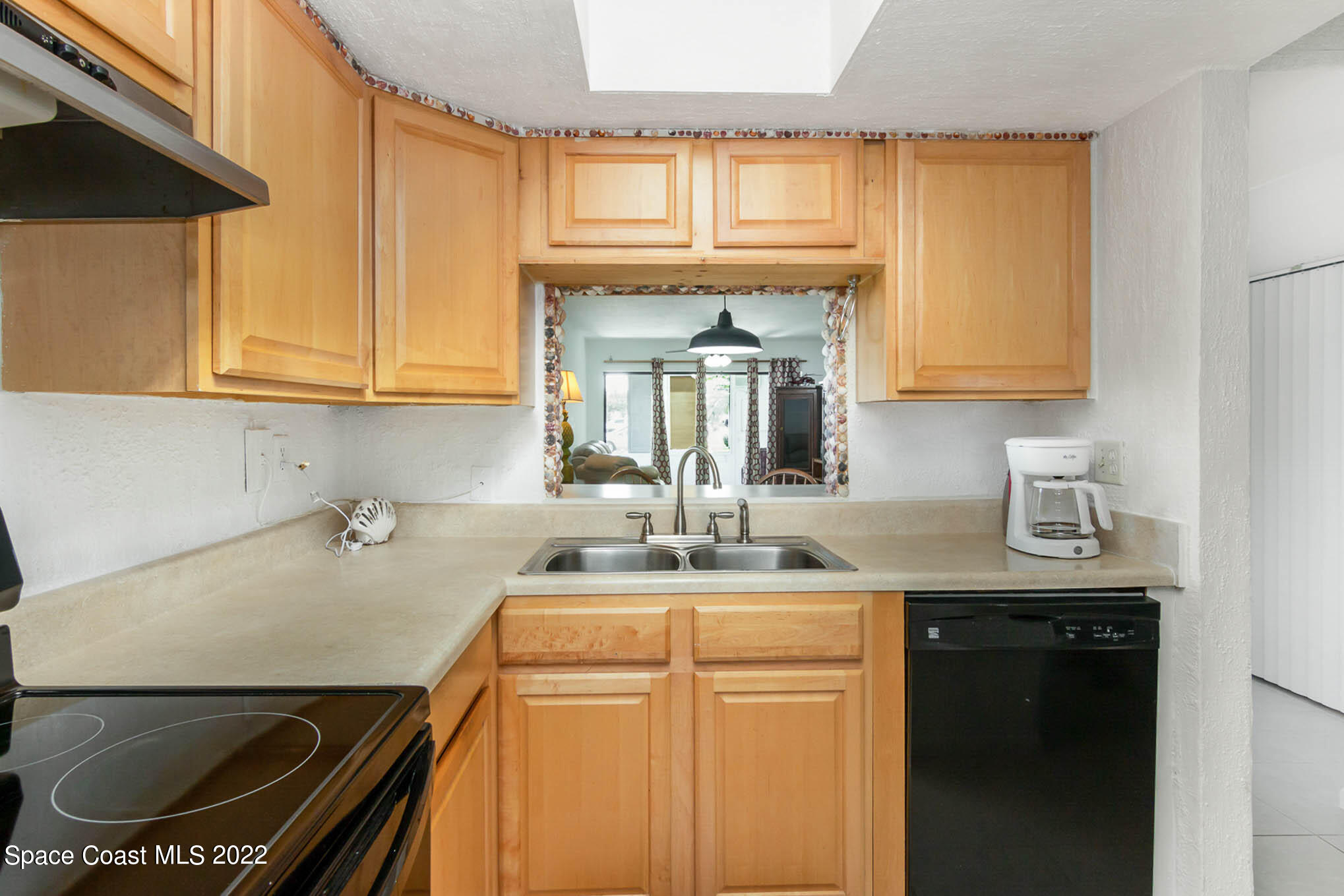 2 Country Club Road, Unit 20 Cocoa Beach, FL 32931 - Photo 8 of 23 a kitchen with a sink a stove cabinets and a window
