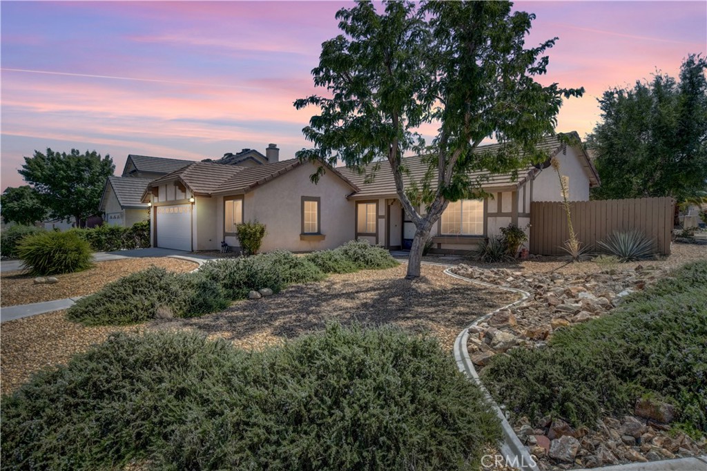 14581 Ponderosa Ranch Road Victorville, CA 92392 - Photo 1 of 1 a front view of a house with a garden
