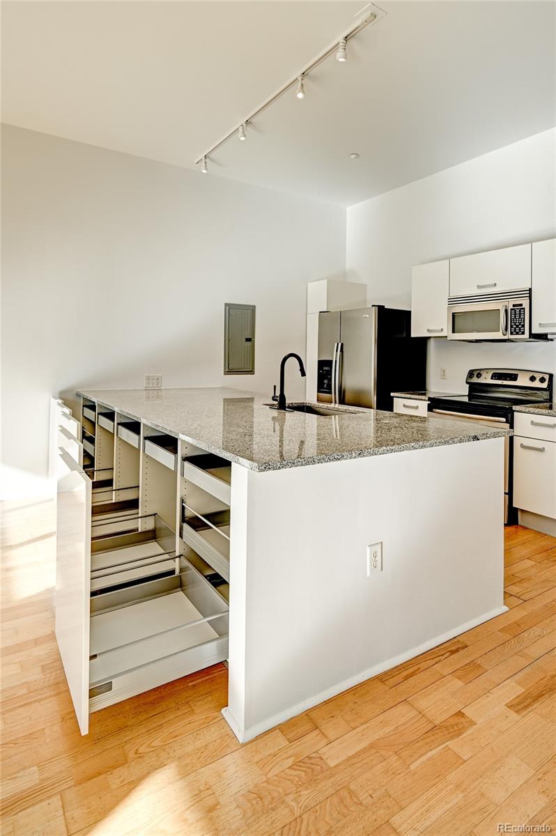 3100 Huron Street, Unit 2C Denver, CO 80202 - Photo 8 of 18 a view of kitchen with cabinets and wooden floor