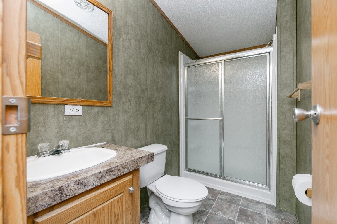 399 Calvert Ridge Road Westmoreland, TN 37186 - Photo 20 of 31 a bathroom with a granite countertop sink toilet and shower