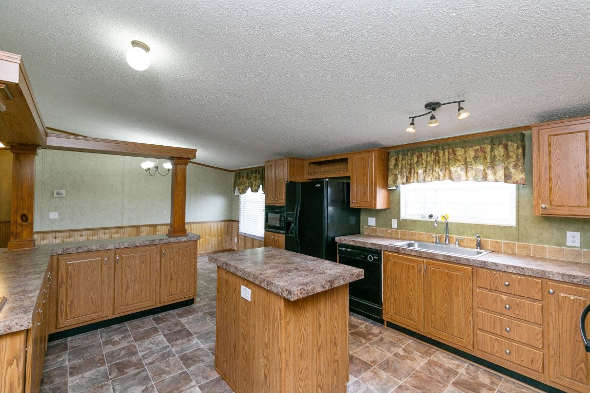 399 Calvert Ridge Road Westmoreland, TN 37186 - Photo 7 of 31 a kitchen with granite countertop a sink and cabinets