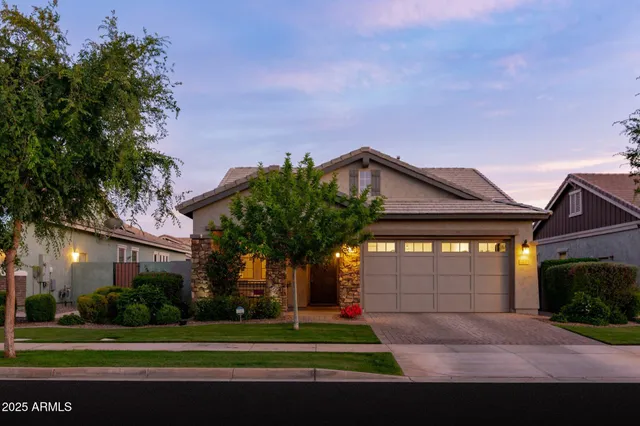 a front view of a house with a yard and garage