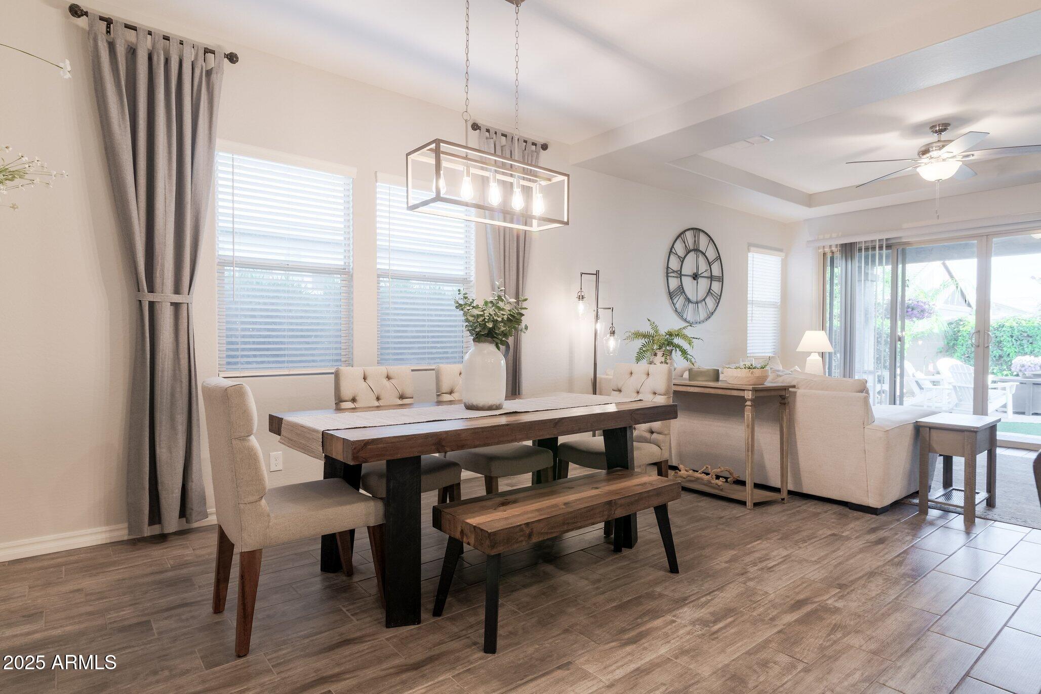 3437 East Appaloosa Road Gilbert, AZ 85296 - Photo 15 of 47 a view of a dining room with furniture window and wooden floor
