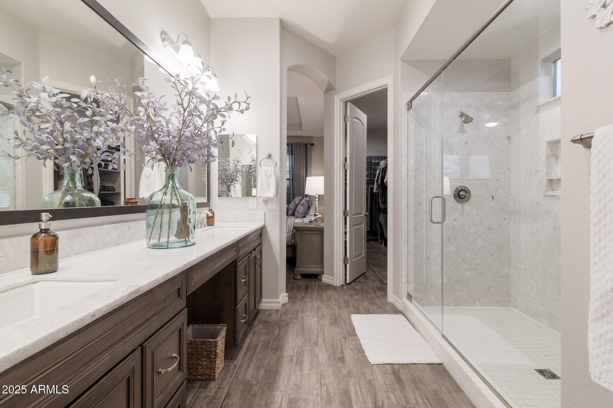 3437 East Appaloosa Road Gilbert, AZ 85296 - Photo 21 of 47 a spacious bathroom with a shower sink and mirror