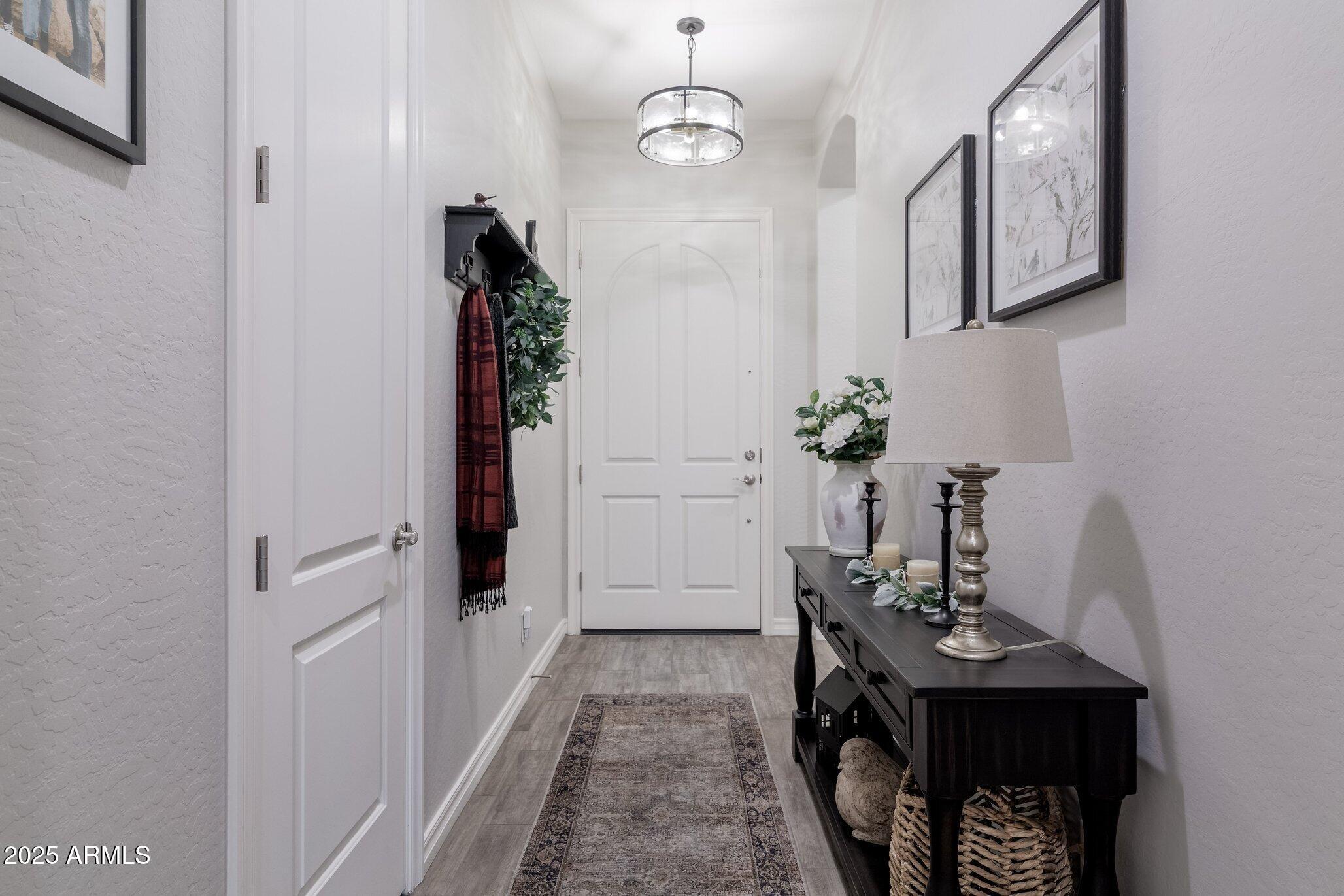 3437 East Appaloosa Road Gilbert, AZ 85296 - Photo 26 of 47 a view of a hallway to a livingroom and furniture
