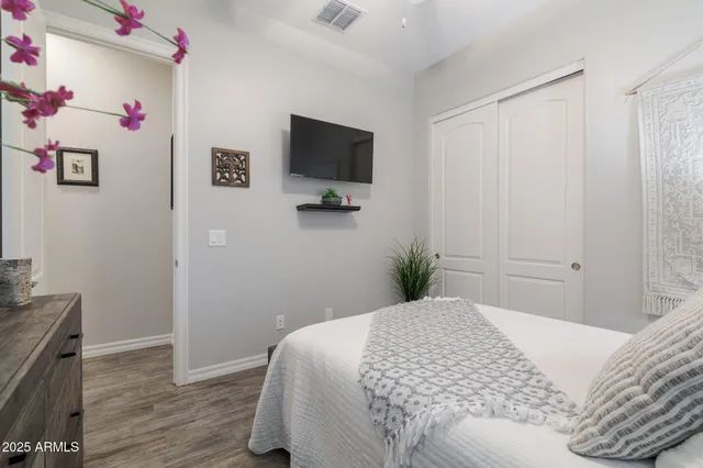 a bedroom with a bed and a flat screen tv