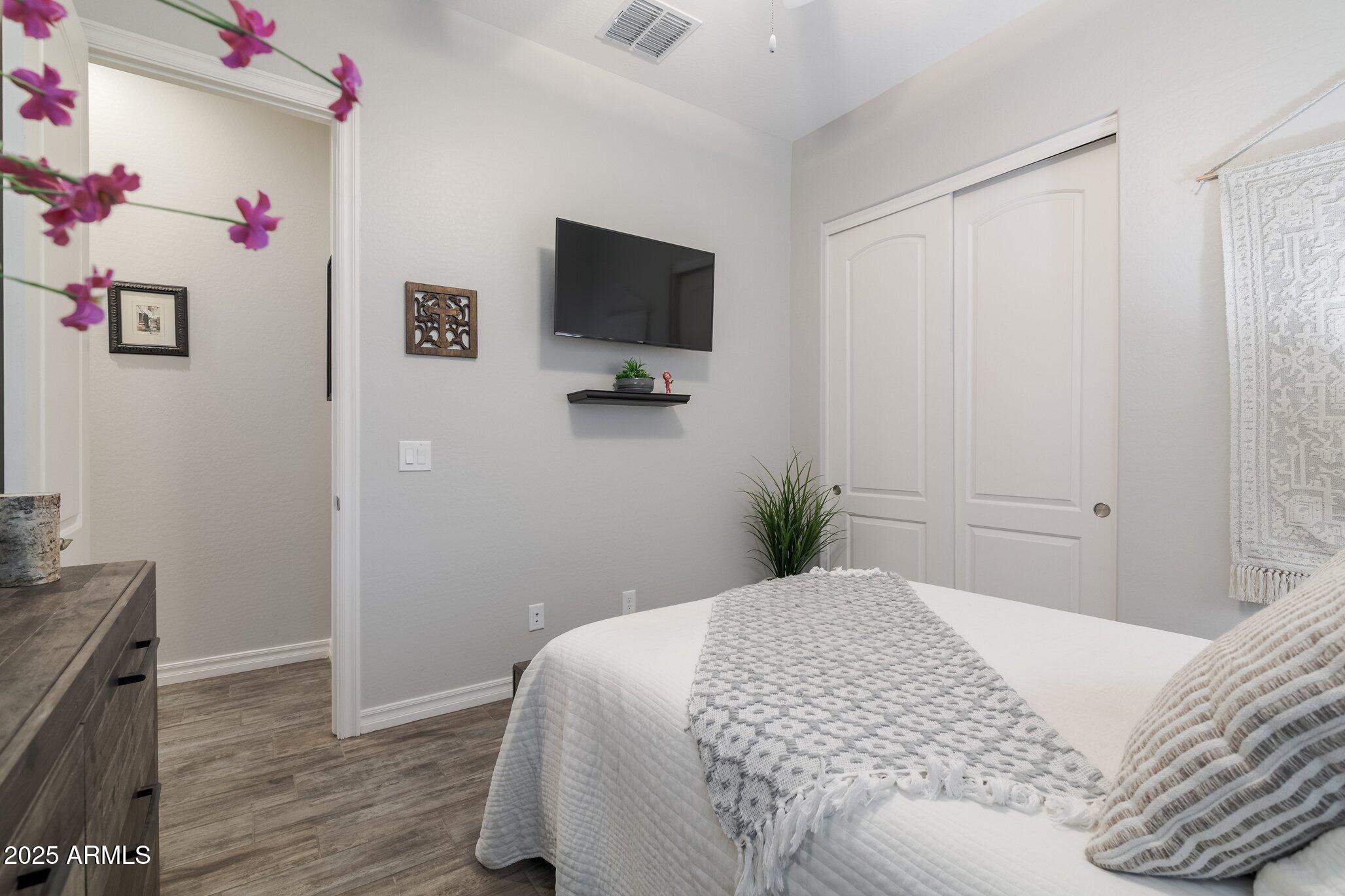 3437 East Appaloosa Road Gilbert, AZ 85296 - Photo 27 of 47 a bedroom with a bed and a flat screen tv