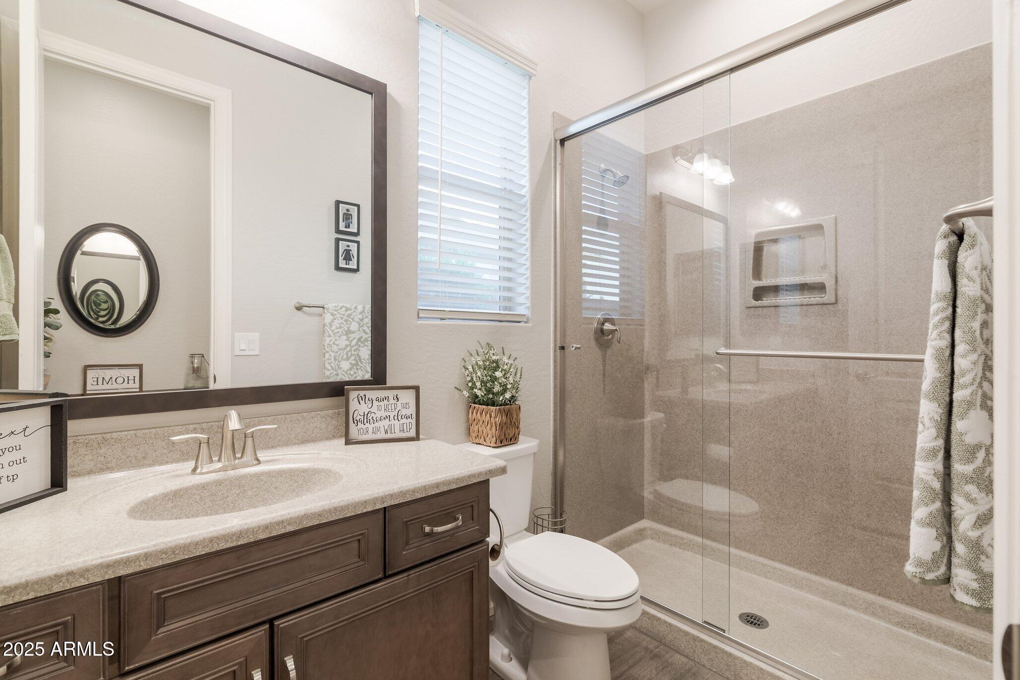 3437 East Appaloosa Road Gilbert, AZ 85296 - Photo 29 of 47 a bathroom with a granite countertop sink toilet mirror and shower