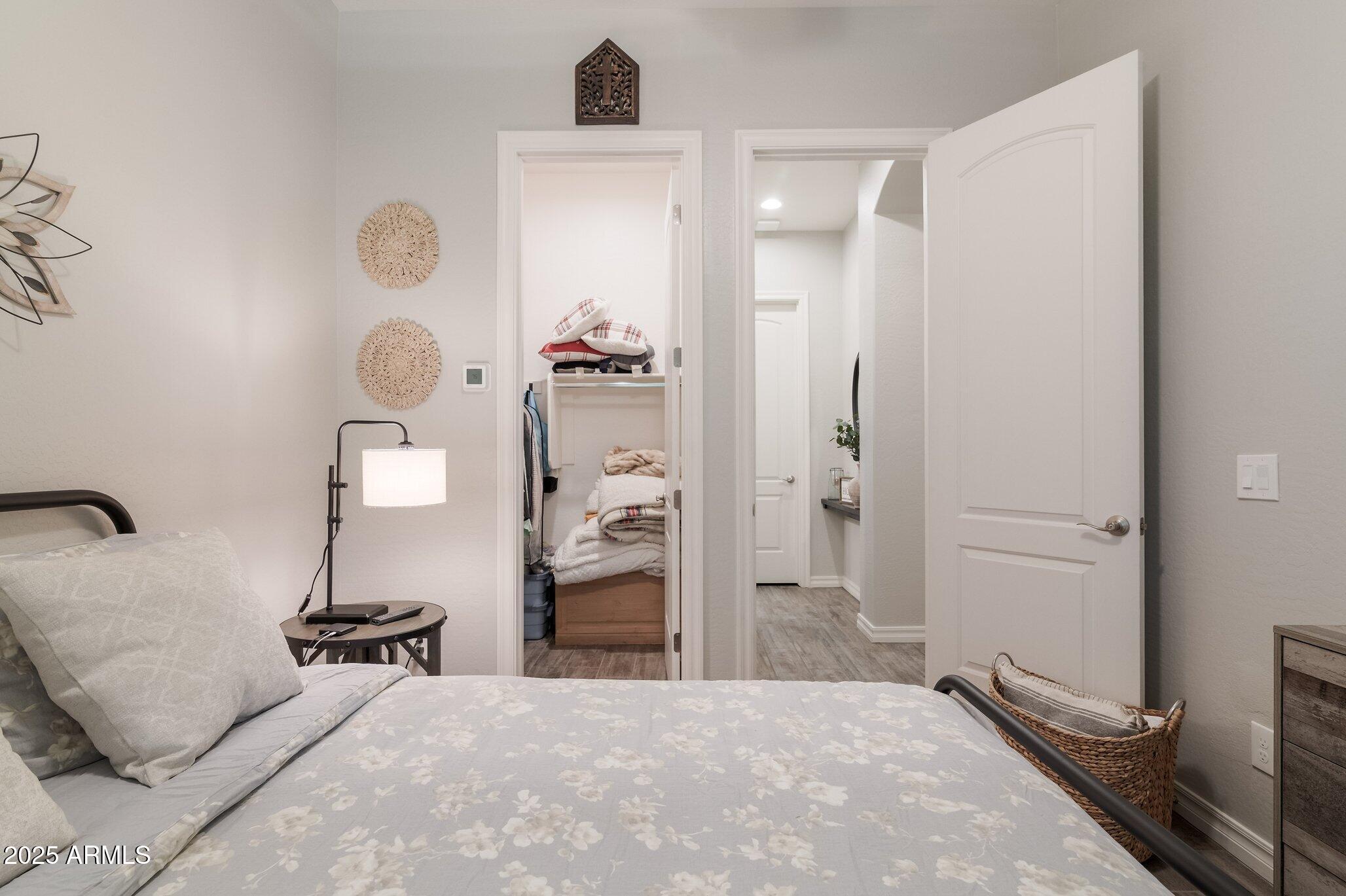 3437 East Appaloosa Road Gilbert, AZ 85296 - Photo 30 of 47 a spacious bedroom with a bed and a chandelier