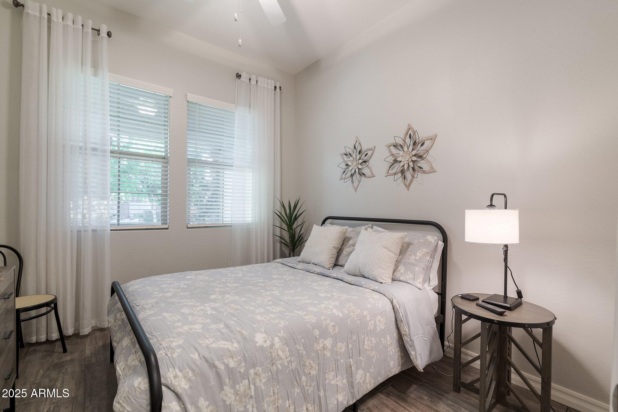 3437 East Appaloosa Road Gilbert, AZ 85296 - Photo 31 of 47 a bedroom with a bed and a table lamp