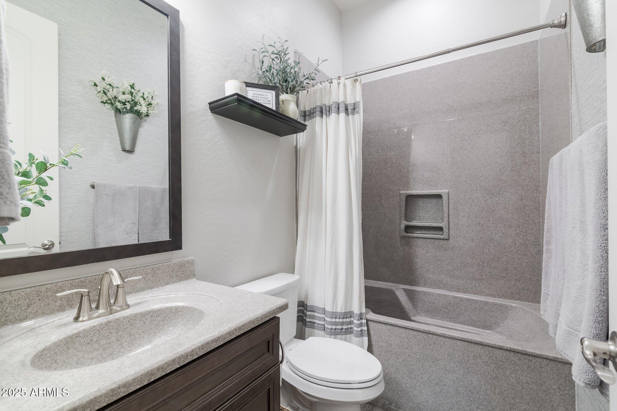 3437 East Appaloosa Road Gilbert, AZ 85296 - Photo 32 of 47 a bathroom with a granite countertop sink a toilet and shower