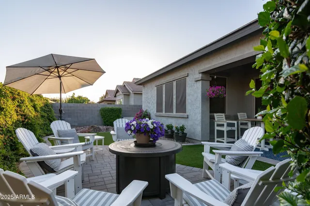 a patio with a patio table and chairs