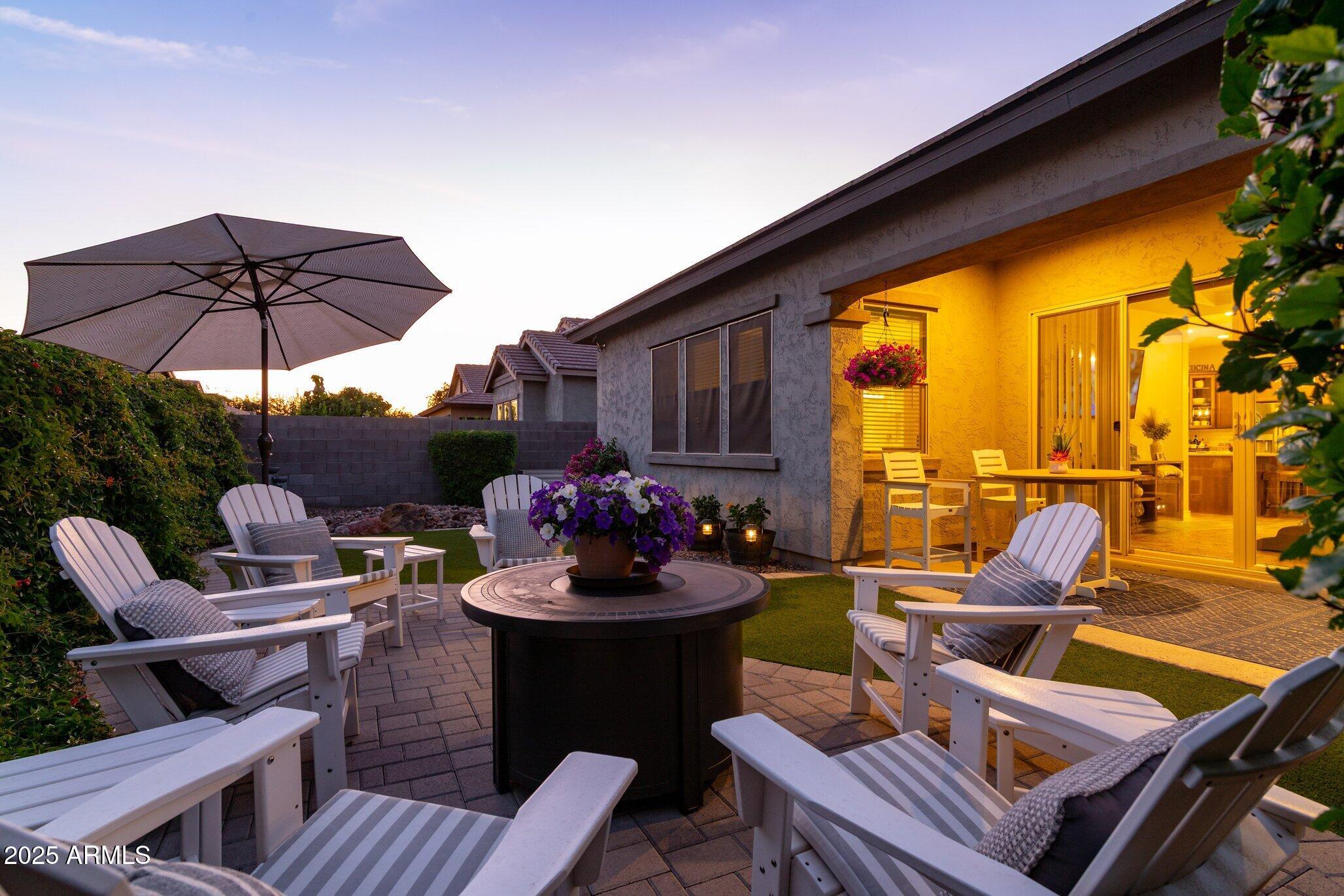3437 East Appaloosa Road Gilbert, AZ 85296 - Photo 35 of 47 a view of a outdoor seating area with furniture and umbrella