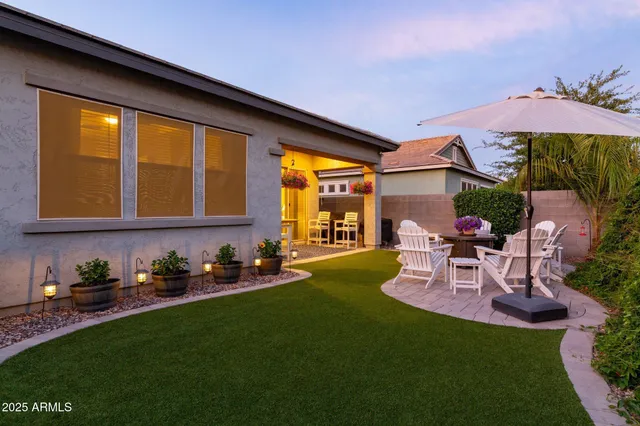 a view of a patio with table and chairs under an umbrella