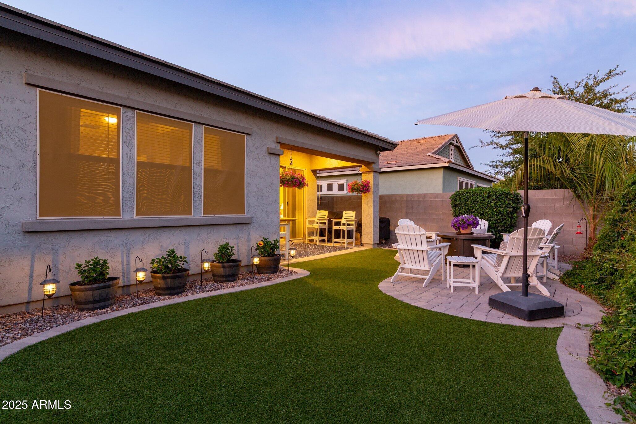 3437 East Appaloosa Road Gilbert, AZ 85296 - Photo 36 of 47 a view of a patio with table and chairs under an umbrella