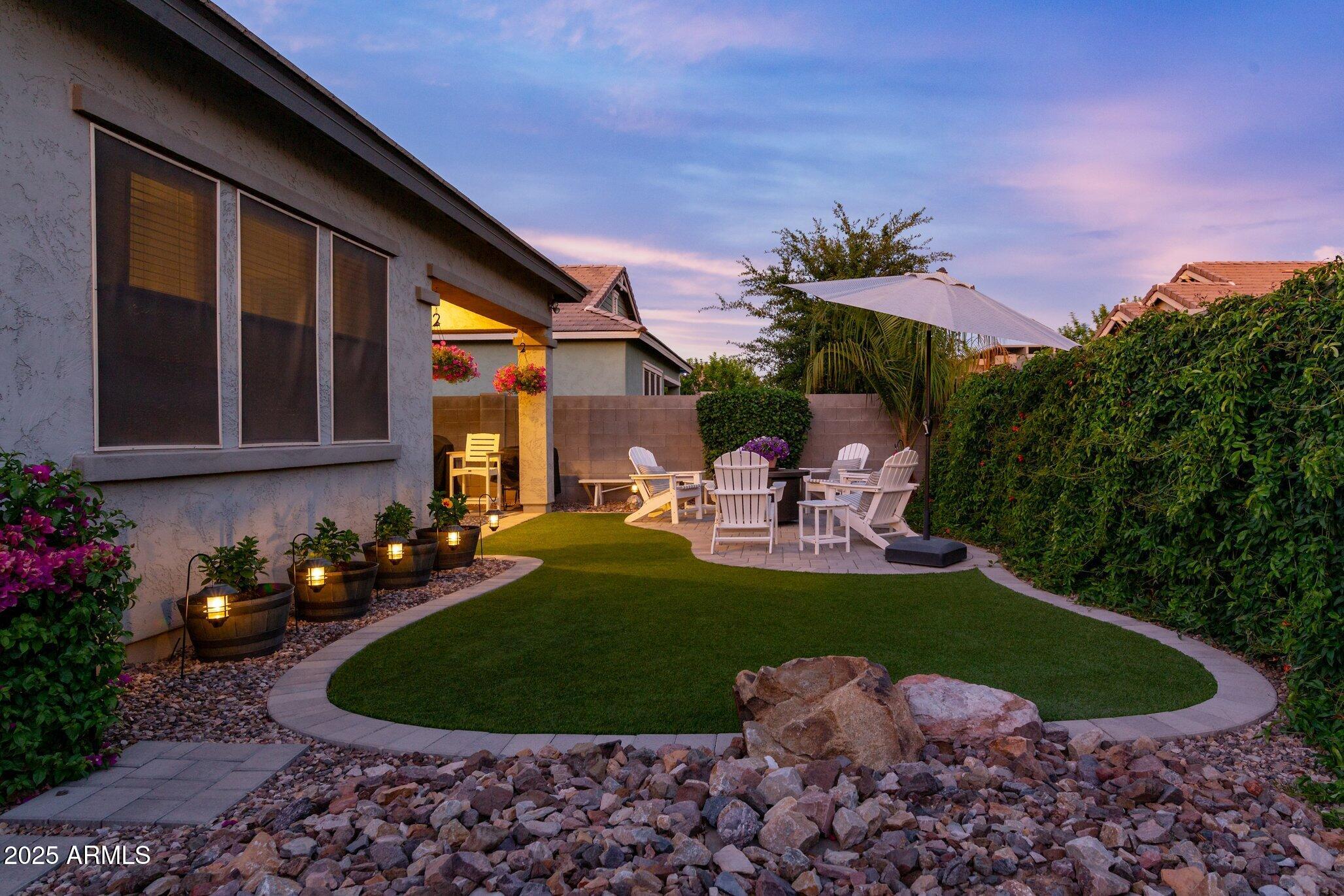 3437 East Appaloosa Road Gilbert, AZ 85296 - Photo 37 of 47 a view of a chair and tables in the backyard