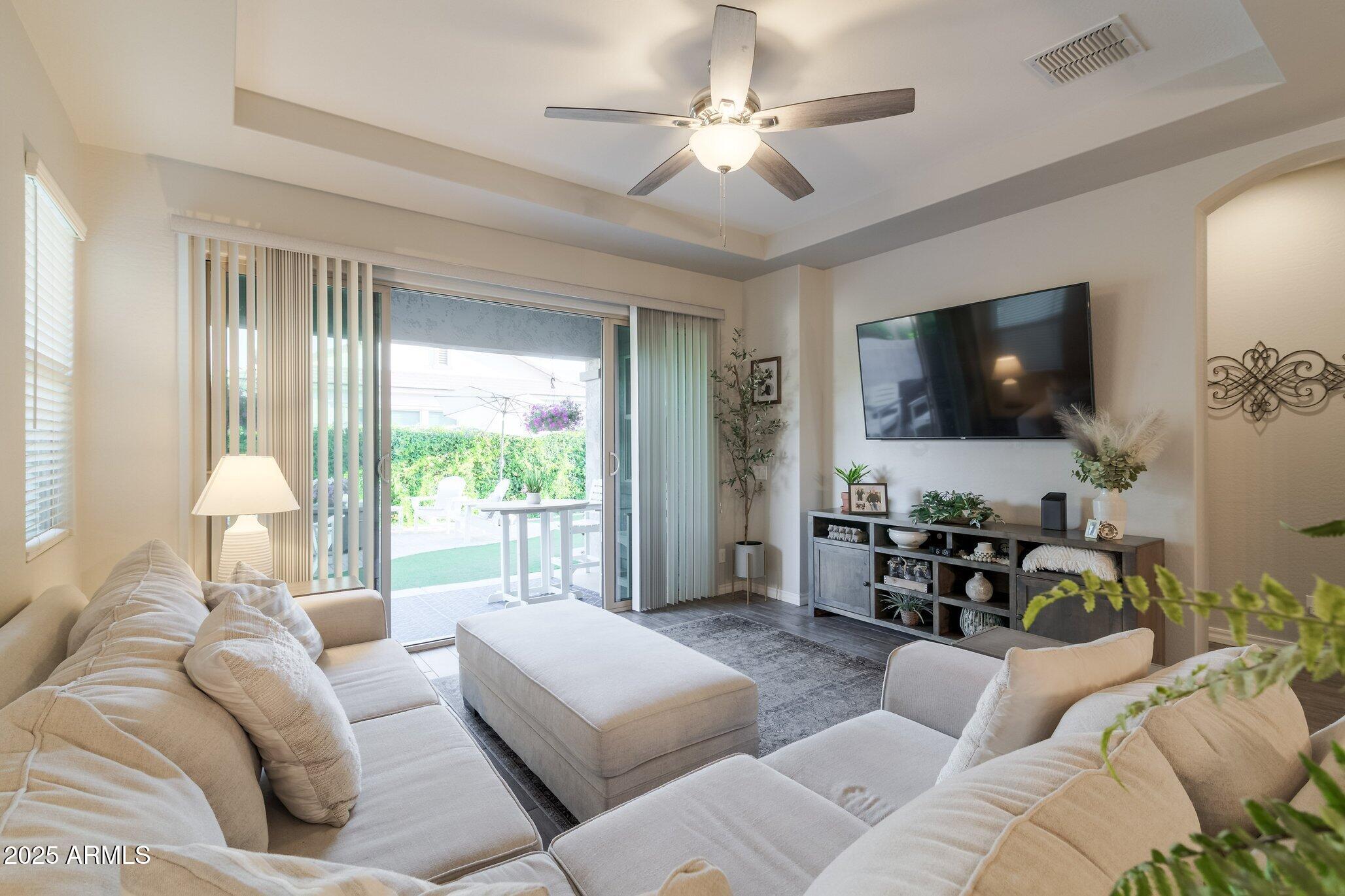 3437 East Appaloosa Road Gilbert, AZ 85296 - Photo 8 of 47 a living room with furniture and a flat screen tv