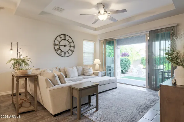 a living room with furniture a table and a large window