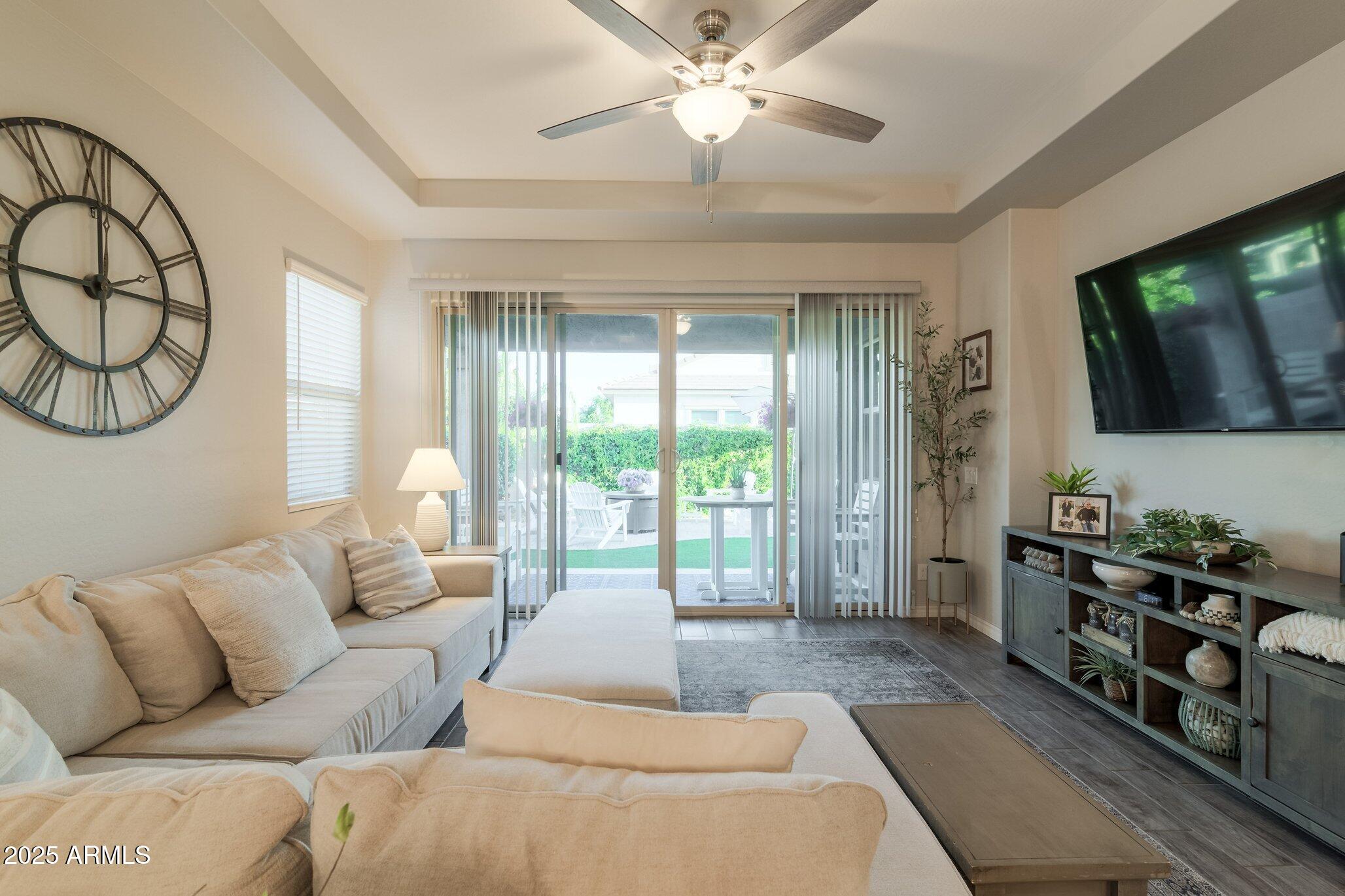 3437 East Appaloosa Road Gilbert, AZ 85296 - Photo 10 of 47 a living room with furniture a flat screen tv and a large window