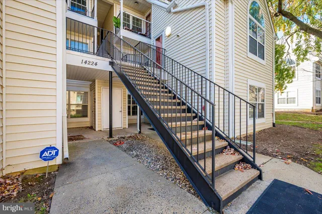 a view of a house with backyard and deck