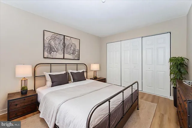 a bedroom with a bed and a potted plant