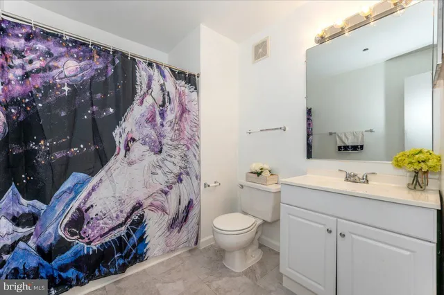 a bathroom with a sink mirror vanity and toilet
