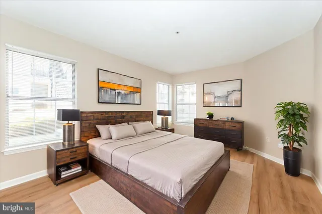 a bedroom with bed and a potted plant