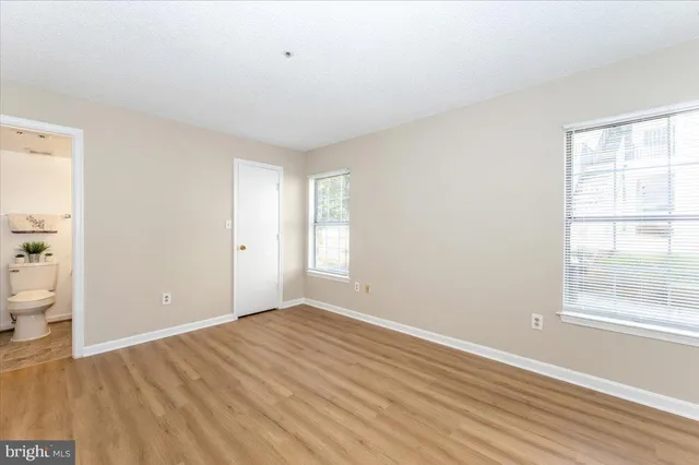 a view of wooden floor and windows in a room