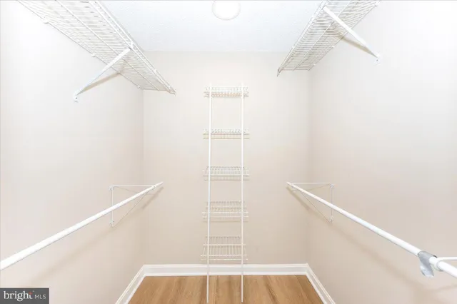 a view of walk in closet with empty racks