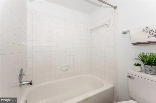 a bathroom with a bathtub and toilet