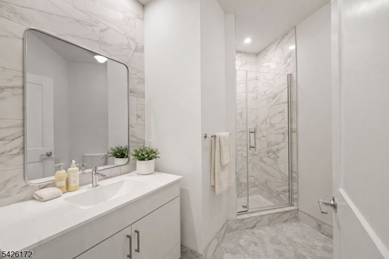 434 Springfield Avenue, Unit 146 Berkeley Heights, NJ 07922 - Photo 11 of 32 a bathroom with a double vanity sink mirror and shower
