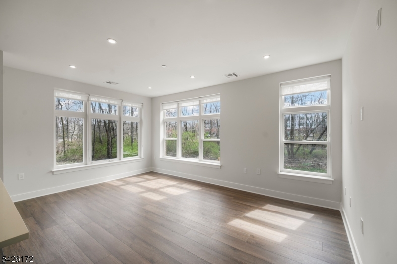 434 Springfield Avenue, Unit 146 Berkeley Heights, NJ 07922 - Photo 21 of 32 a view of an empty room with a window and wooden floor