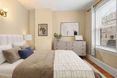 a bedroom with a bed and a dresser