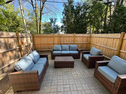 a roof deck with couches and potted plant