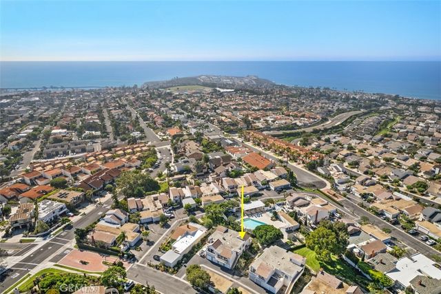 an aerial view of residential building and trees around