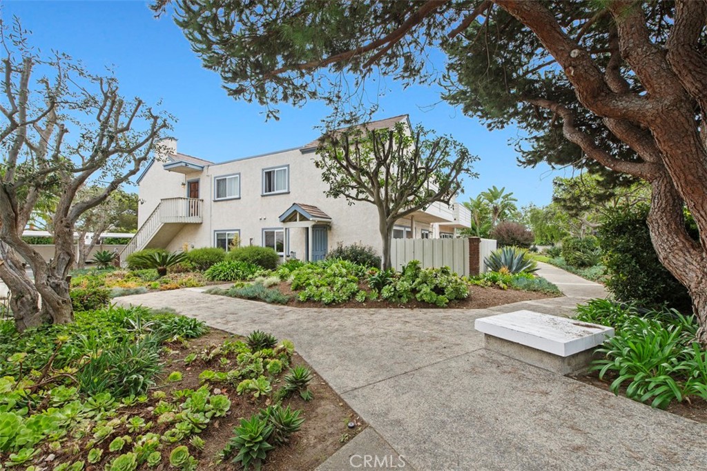 33623 Avenida Capri, Unit 60 Dana Point, CA 92629 - Photo 22 of 38 a front view of a house with a yard and a garden